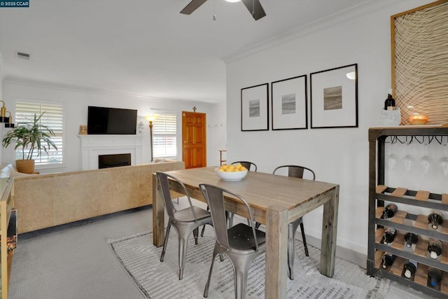 dining area featuring ceiling fan and crown molding