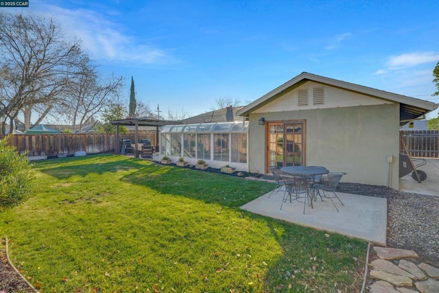 back of house with a pergola, a lawn, and a patio