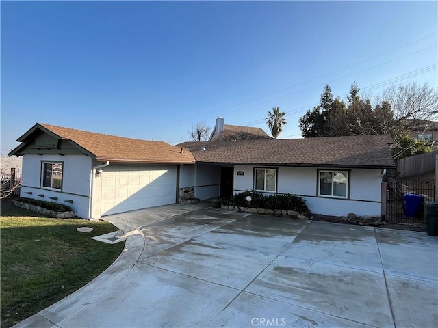 single story home with a garage and a front yard