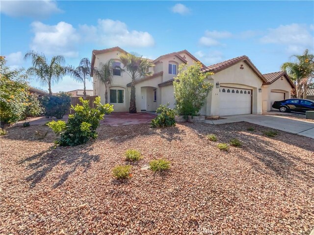 mediterranean / spanish-style house with a garage