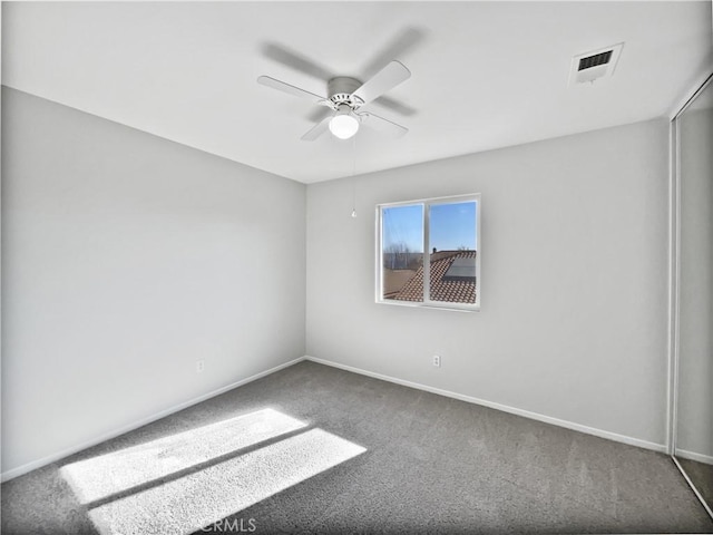 empty room featuring carpet and ceiling fan