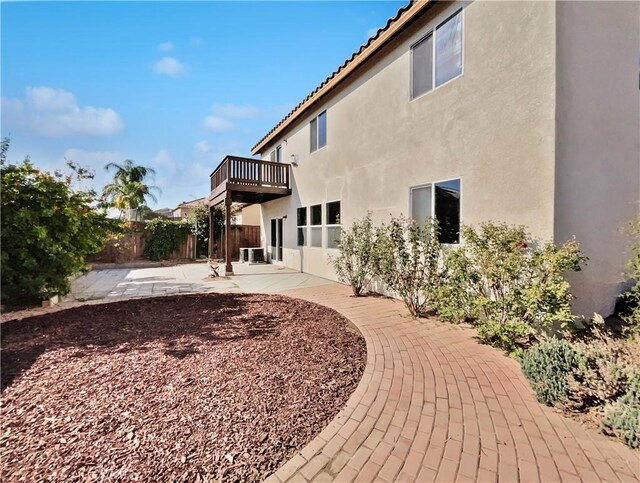 rear view of house with a balcony and a patio area