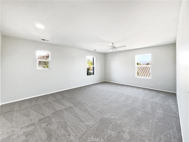 empty room with ceiling fan and carpet floors