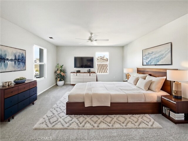 bedroom with light colored carpet and ceiling fan