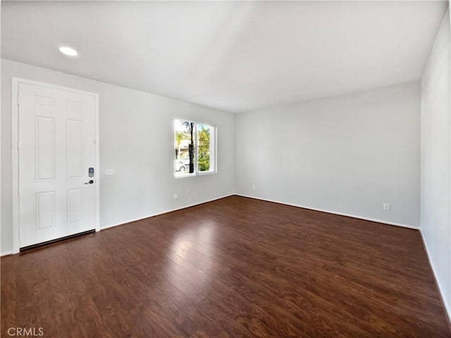 empty room with dark wood-type flooring