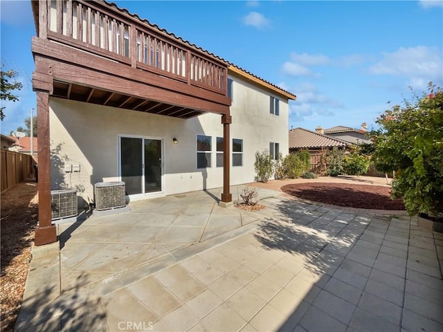 rear view of house featuring cooling unit and a patio