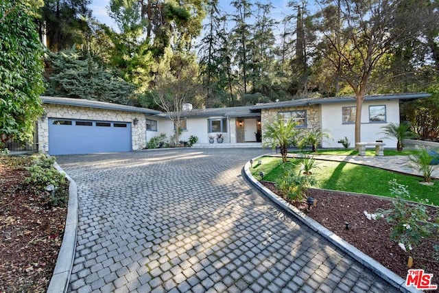 ranch-style home featuring a garage