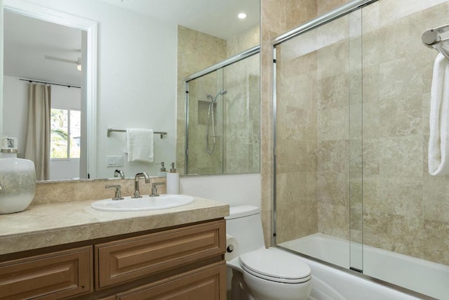 full bathroom with bath / shower combo with glass door, vanity, and toilet