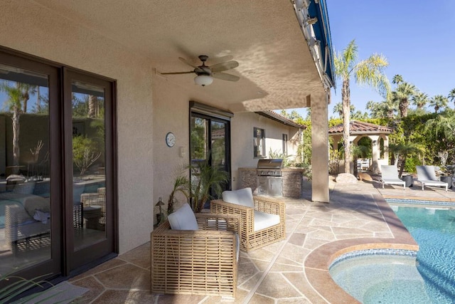 view of patio featuring area for grilling, ceiling fan, and exterior kitchen