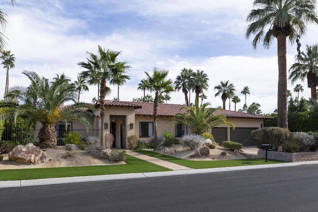 mediterranean / spanish home featuring a garage