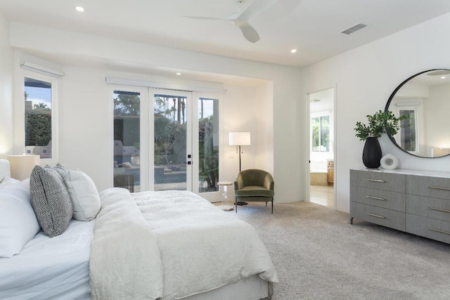 bedroom with ceiling fan, ensuite bathroom, access to exterior, and light colored carpet