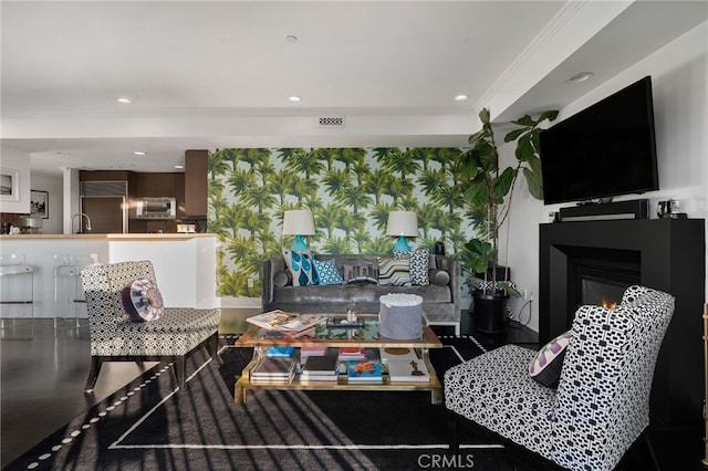 living room with crown molding and hardwood / wood-style flooring