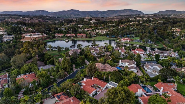 aerial view at dusk with a water and mountain view