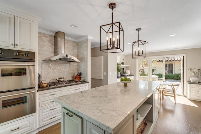 kitchen featuring crown molding, wall chimney exhaust hood, open shelves, and stainless steel appliances