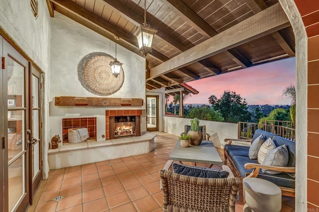 interior space with an outdoor living space with a fireplace