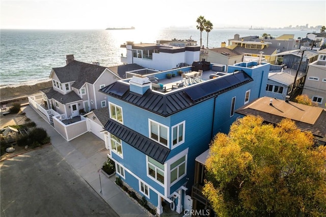 drone / aerial view featuring a water view and a residential view