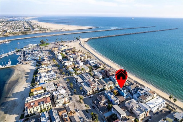 drone / aerial view with a water view and a beach view