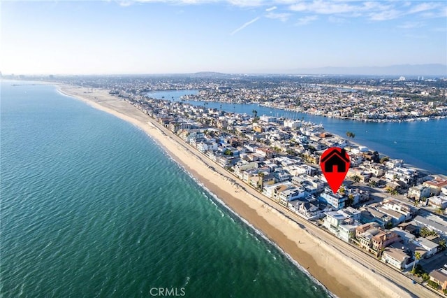 birds eye view of property with a view of the beach and a water view