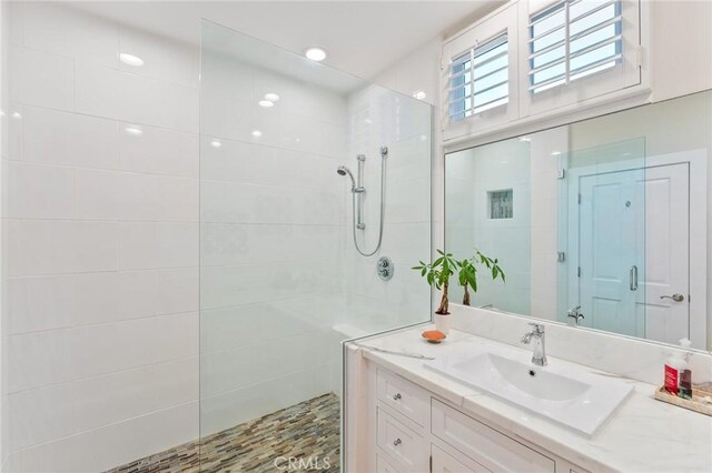 bathroom featuring vanity and a tile shower