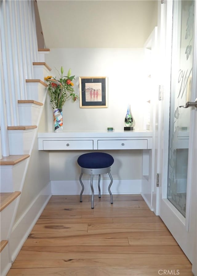 office space with wood finished floors and baseboards