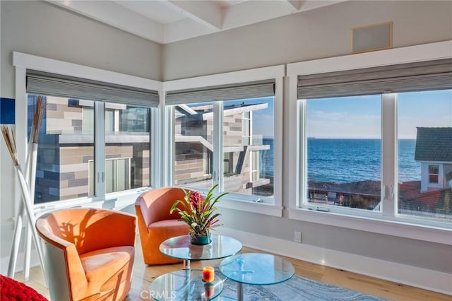 sunroom / solarium featuring a water view