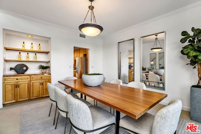 dining room featuring light carpet and ornamental molding