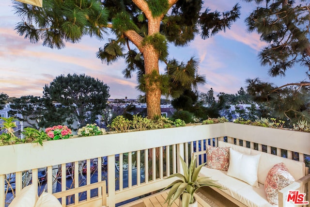 balcony at dusk with an outdoor living space