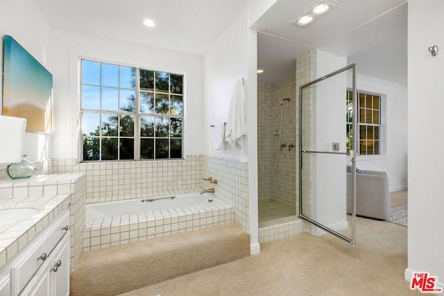 bathroom featuring independent shower and bath and vanity