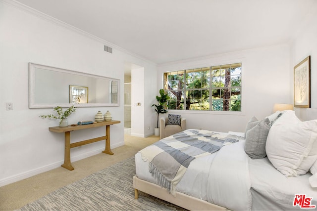 bedroom featuring crown molding and light colored carpet