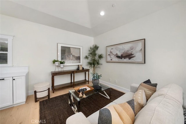 living room with recessed lighting, light wood-style flooring, and baseboards