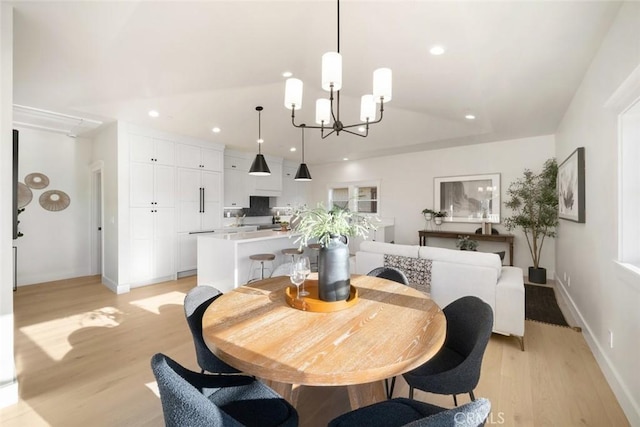 dining room featuring light hardwood / wood-style flooring and an inviting chandelier