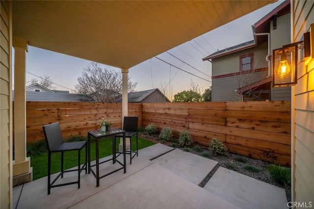 view of patio terrace at dusk