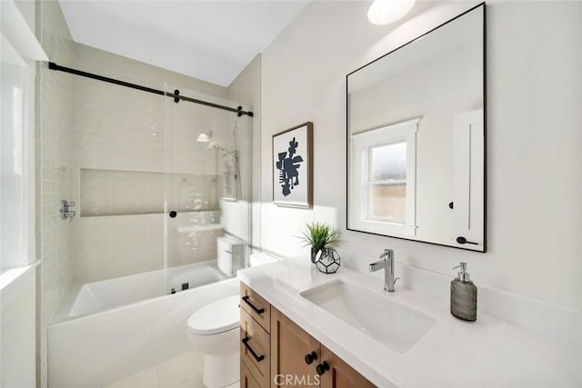 bathroom featuring vanity, toilet, and shower / bathtub combination