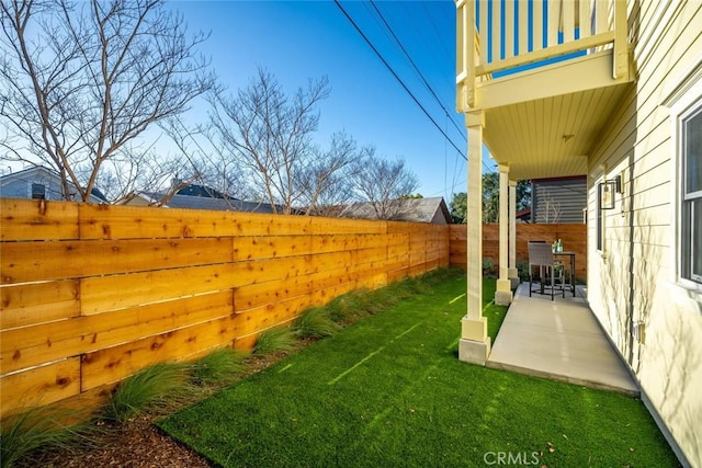 view of yard featuring a balcony and a patio area