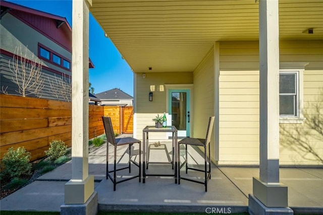 view of patio featuring fence and outdoor dining area