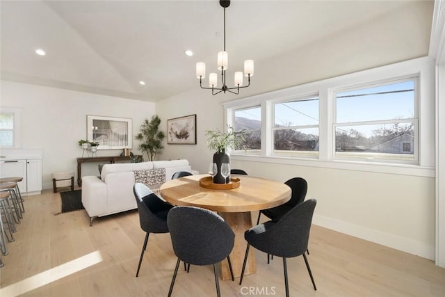 dining space featuring light hardwood / wood-style flooring and a notable chandelier