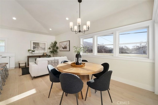 dining room with light wood-style floors, plenty of natural light, vaulted ceiling, and recessed lighting