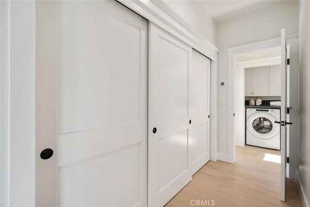 hall featuring washer / clothes dryer and light wood-type flooring