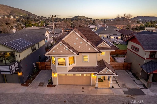 view of front facade featuring a garage and a mountain view