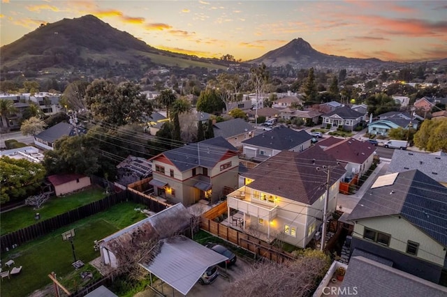 aerial view at dusk featuring a residential view and a mountain view