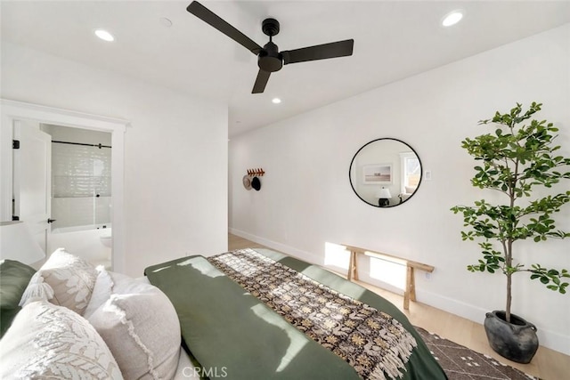 bedroom with ceiling fan, wood-type flooring, and ensuite bath