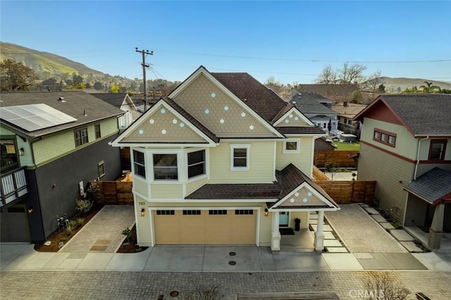 view of front facade with a garage and a mountain view