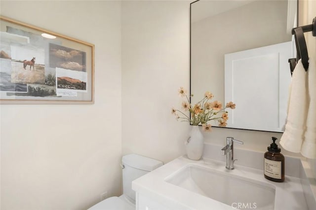 bathroom featuring toilet and vanity