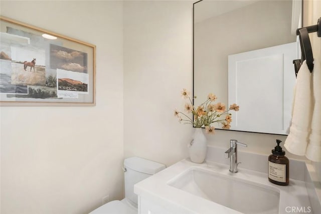 bathroom featuring toilet and vanity