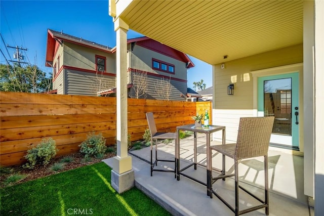 view of patio / terrace featuring fence and outdoor dining space