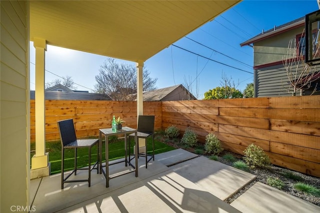 view of patio with a fenced backyard and outdoor dining space