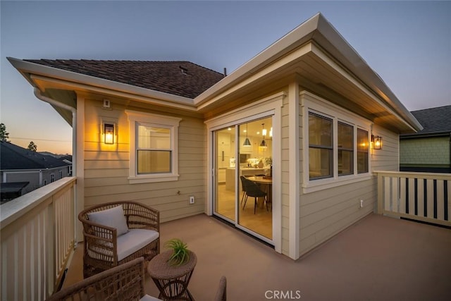 exterior space featuring roof with shingles