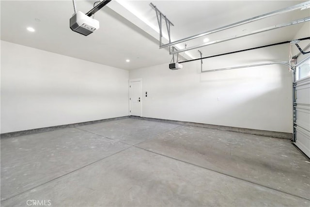 garage with baseboards and a garage door opener