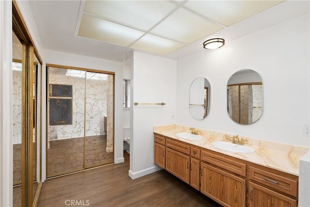 bathroom featuring hardwood / wood-style flooring, toilet, vanity, and walk in shower