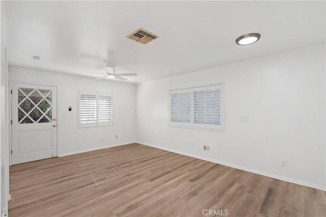 unfurnished room with ceiling fan and light hardwood / wood-style floors